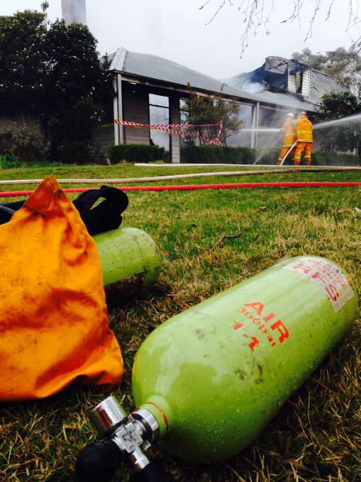 HOUSE FIRE: Firefighters work to save the home at Wallaces Gap Road, however it was destroyed. Photo: Supplied.