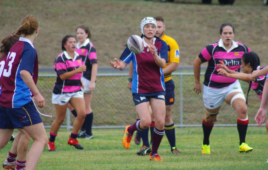 OFFLOADING: Sass Cudaj offloads the ball before she can be tackled during the first game of the Women's Rugby 10s competition at Poidevin Oval. Photos: Darryl Fernance