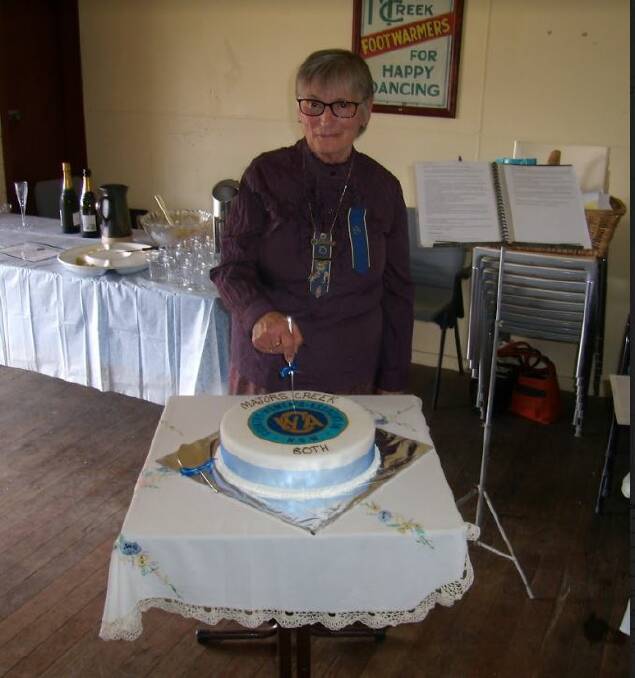 Deirdre McDonald cutting the CWA's 80th birthday cake.