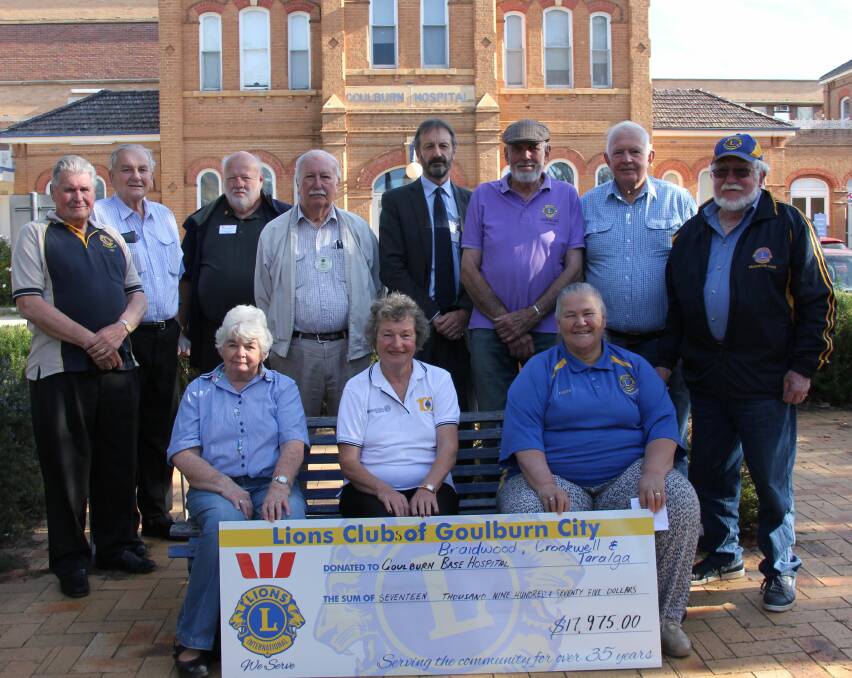 Members of the combined Crookwell, Taralga, Braidwood and Goulburn City Lions Clubs donating funds for a motorised patient trolley for the helipad at Goulburn Hospital. Photo supplied.