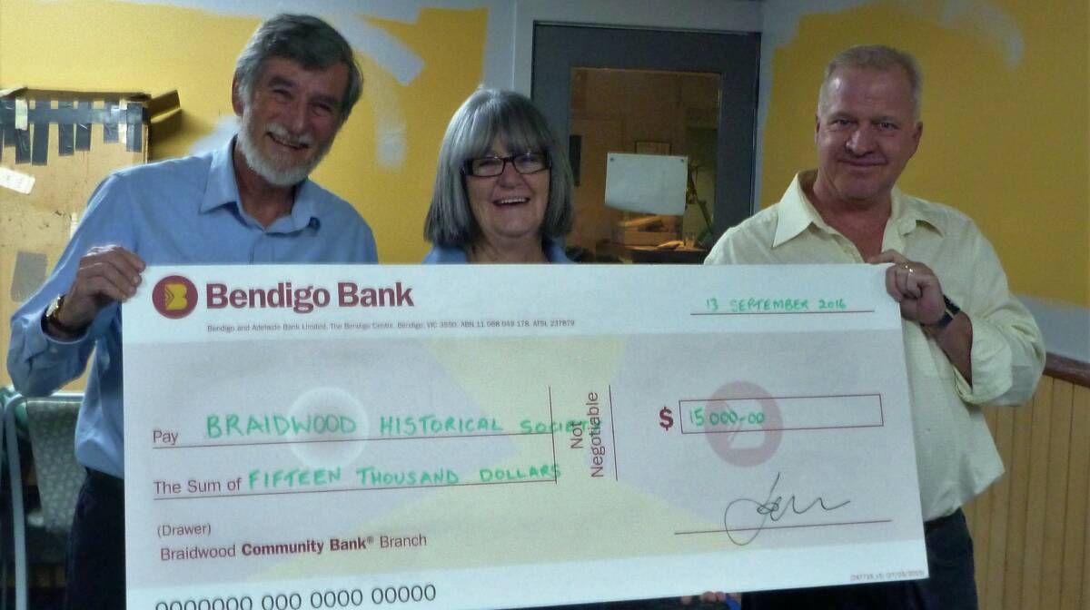 CHEQUE IT OUT: (L-R) Braidwood and District Historical Society president Peter Smith, Braidwood Community Bank director Mary Mathias and bank manager Nicholas Fry with the $15,000 donation to April's re-enactment. Photo: supplied