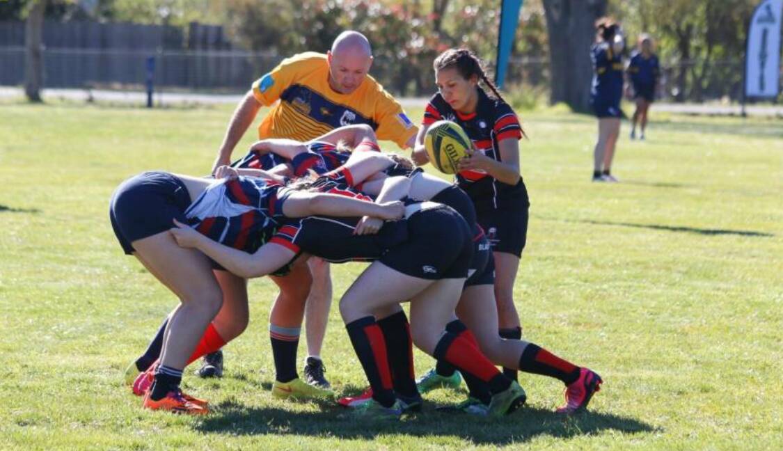 First win: The Braidwood Black Widows take a scrum against ADFA during game one of the third ACT Brumbies' Rugby 7s series. The result was 12-0 in favour of the Black Widows—the team's first-ever win. Photo: Kathy Toirkens