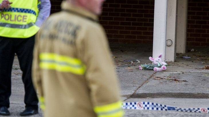Police and ACT Fire & Rescue crews outside the Queanbeyan unit where a fire claimed the life of a one-year-old girl. Photo: Jay Cronan