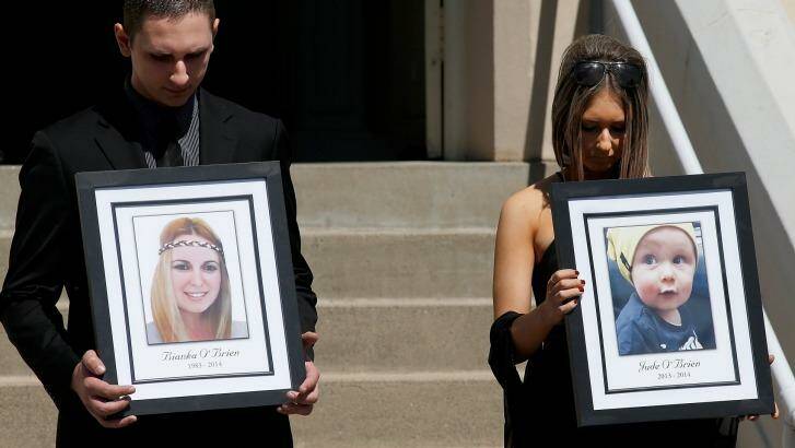 Relatives of the Rozelle blast victims Bianka and Jude O'Brien carry their photographs during their funeral service at St Joseph's Catholic Church. Photo: Daniel Munoz
