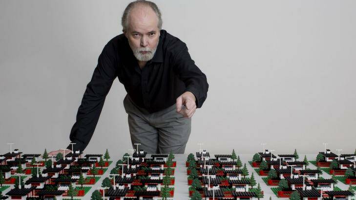 Douglas Coupland with a work from his survey art exhibition in Vancouver, <i>Everywhere is Anywhere is Anything is Everything</i>. Photo: Brian Howell