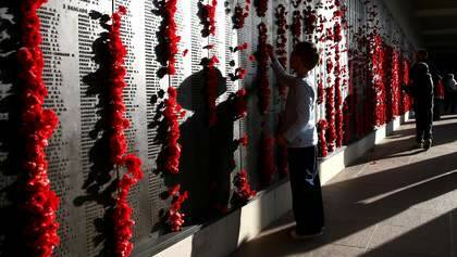 6-year-old Will Jenkins from Newcastle places a poppy on the Wall of Remembrance at the Australian War Memorial in Canberra after the Dawn Service, on Friday 25 April 2014. Photo: Alex Ellinghausen