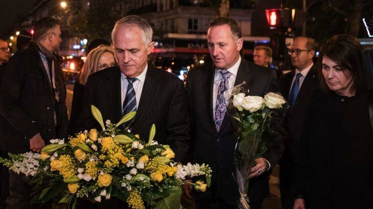 Australian Prime Minister Malcolm Turnbull joins New Zealand's John Key to lay flowers for victims of the Paris terror attacks. Photo: Kamil Zihnioglu