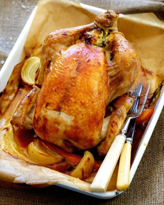 Adam Liaw's classic roast chicken with bread and butter stuffing <a href="http://www.goodfood.com.au/good-food/cook/recipe/classic-roast-chicken-with-bread-and-butter-stuffing-20140324-35d82.html"><b>(recipe here).</b></a> Photo: Edwina Pickles
