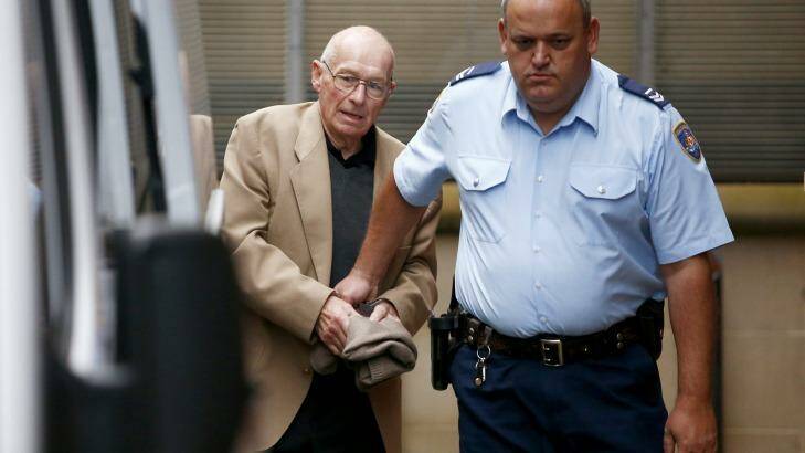 Roger Rogerson is escorted from court during his trial for the murder of Jamie Gao. Photo: Daniel Munoz
