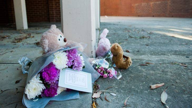 Foral tributes lay in front of the unit tower where a one-year-old girl died. 
 Photo: Elesa Kurtz