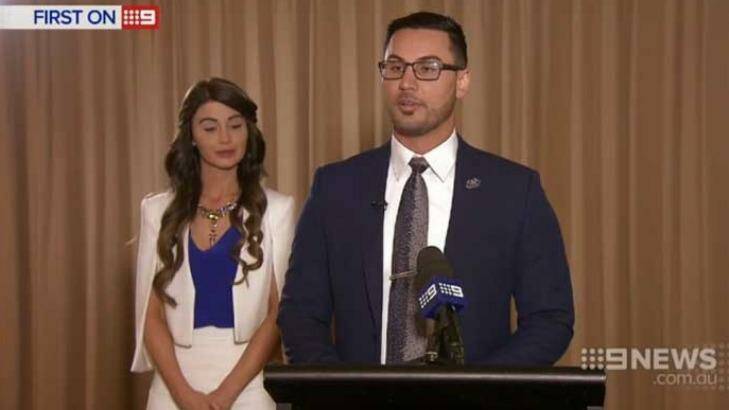 Salim Mehajer at a lectern, with his wife Aysha beside him, during his interview with Nine News. Photo: Channel Nine