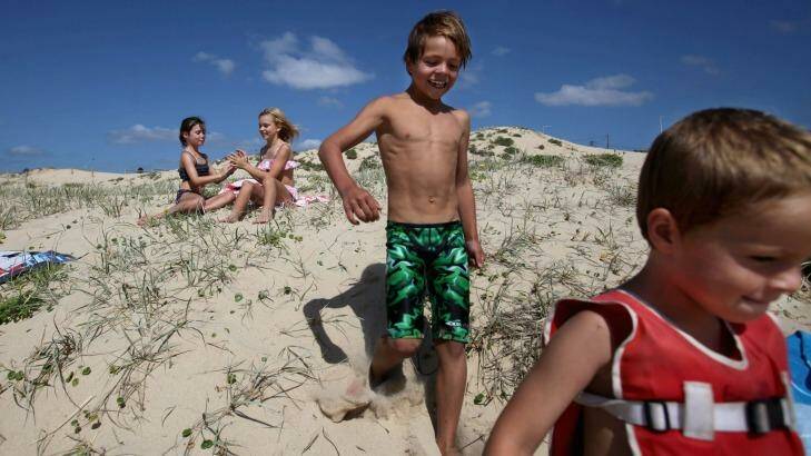 Children play in the sands dunes at Cronulla Beach on Saturday. Photo: Fiona Morris