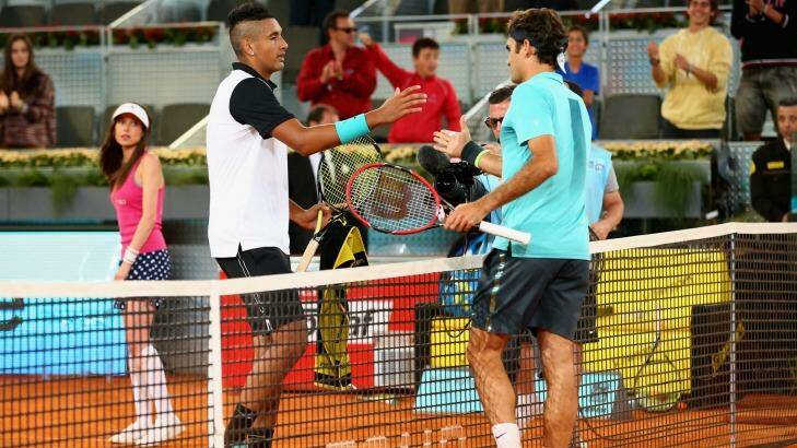 Kyrgios and Federer shake hands after the Canberran's three set victory. Photo: Clive Brunskill