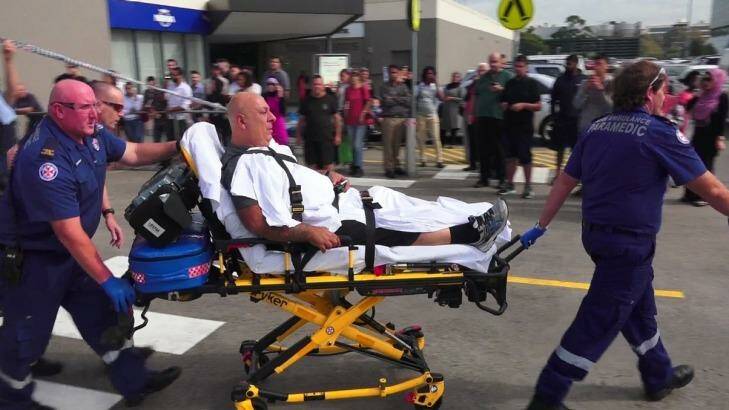 A victim is taken away after a shooting at Bankstown Shopping Centre. Photo: Top Notch Video 