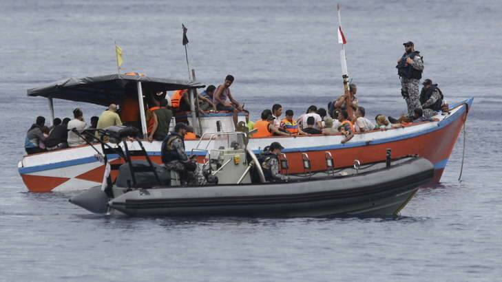 A boatload of asylum seekers are processed by Australian Customs and Dept of Immigration staff at Flying Fish Cove, Christmas Island. Photo: Wolter Peeters
