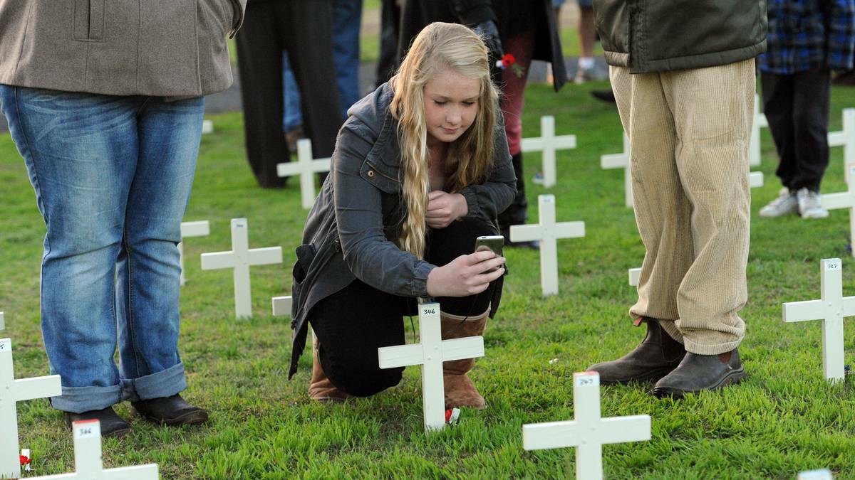 WIMMERA: Abbey Ballinger at the cross of her great uncle Albert Taylor at Horsham Anzac Day service. Photo: Paul Carracher, The Wimmera Mail Times. 