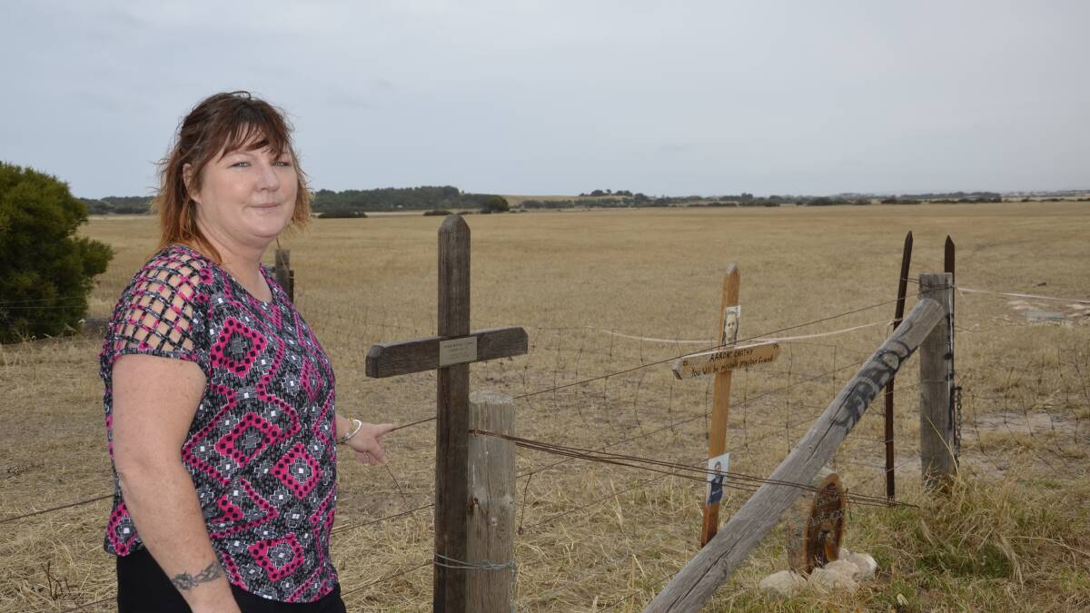 Michelle Kilpatrick's son Aaron Carthy took his own life in March 2012. She is pictured at the roadside memorials on Kessell Road in Goolwa, which Alexandrina Council are asking her to remove.