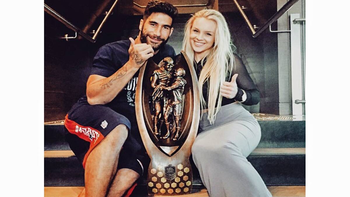 North Queensland Cowboy’s hero, James Tamou with his partner, local girl Brittney McGlone with Rugby League’s most cherished prize, the Provan-Summons Trophy. 