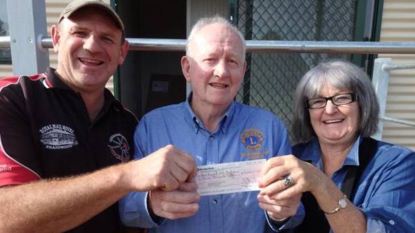 Radio representatives Gordon Waters and Mary Mathias excited to be receiving the Cheque being presented by Lions member John Thomas.   