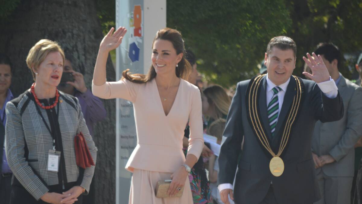 The Duchess waves to the people as she is greeted by the Mayor of Playford Glenn Docherty.