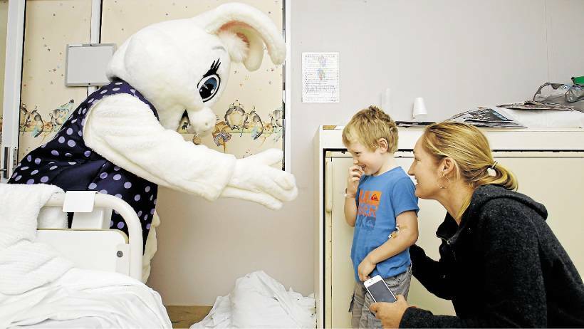 NEWCASTLE: The Easter Bunny greets Ryan Galea, 5, with his mother Belinda, of Kilaben Bay, at John Hunter Hospital. Picture: Max Mason-Hubers/Newcastle Herald