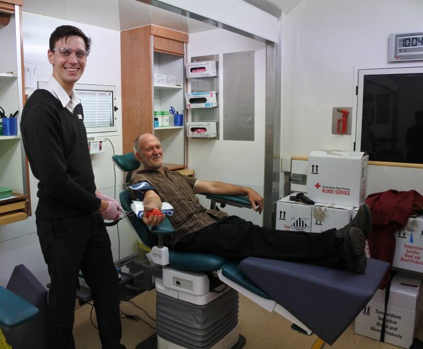 Jacob Ward takes Gilles Bonin's blood at the Mobile Donor Centre in Ryrie Park. Photo: Elspeth Kernebone.