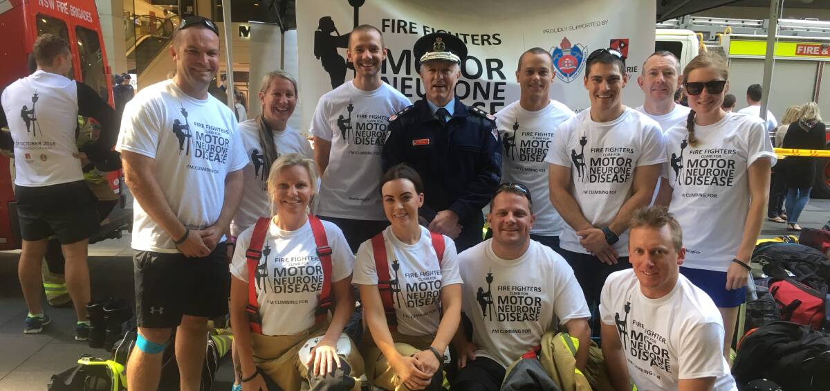 UP HIGH: Members of 'Where's the lift?' with the Commissioner of Fire and Rescue NSW after completing their ascent of the Sydney Tower Eye. Photo: Nicky Clarke.