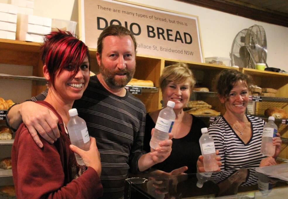 BOTTLED-UP: The team at Dojo Bread selling bottled water. Photo: Celia Roach.