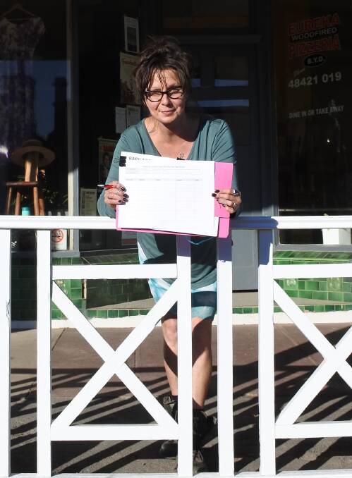 SIGN HERE: Julia Gibb has placed copies of the Nerriga Road petition around the town in the hope of reaching those without internet access. Photo: Elspeth Kernebone