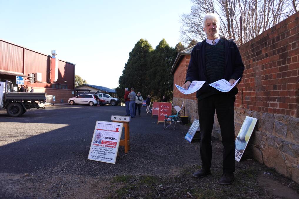 Saturday's poll: Former Palerang councillor Paul Cockram hands out 'How to Vote' cards. Photo: Elspeth Kernebone