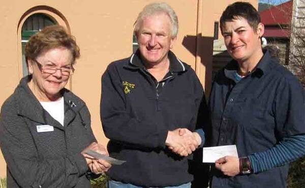 Geoff Bunn from the Lodge of Truth presenting cheques to Cathy Ffrench from St Vincent de Paul and Jo Parsons from the Duke of Edinburgh Awards.