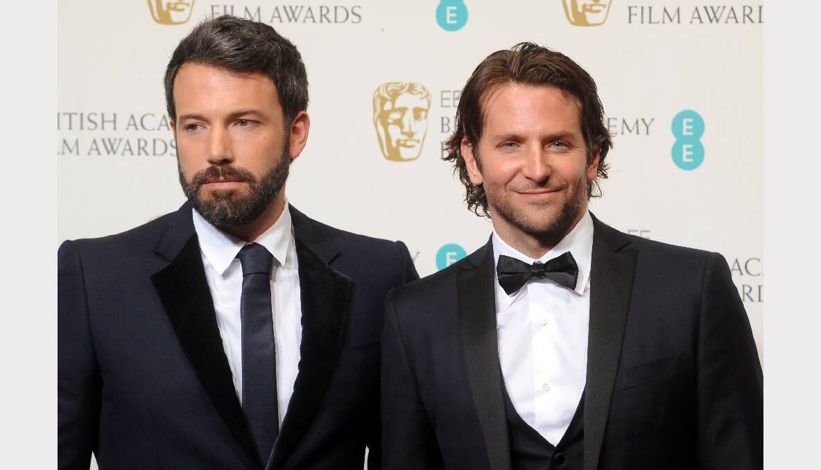 Presenters of Outstanding British Film Ben Affleck and Bradley Cooper pose in the press room. Photos: GETTY IMAGES, REUTERS