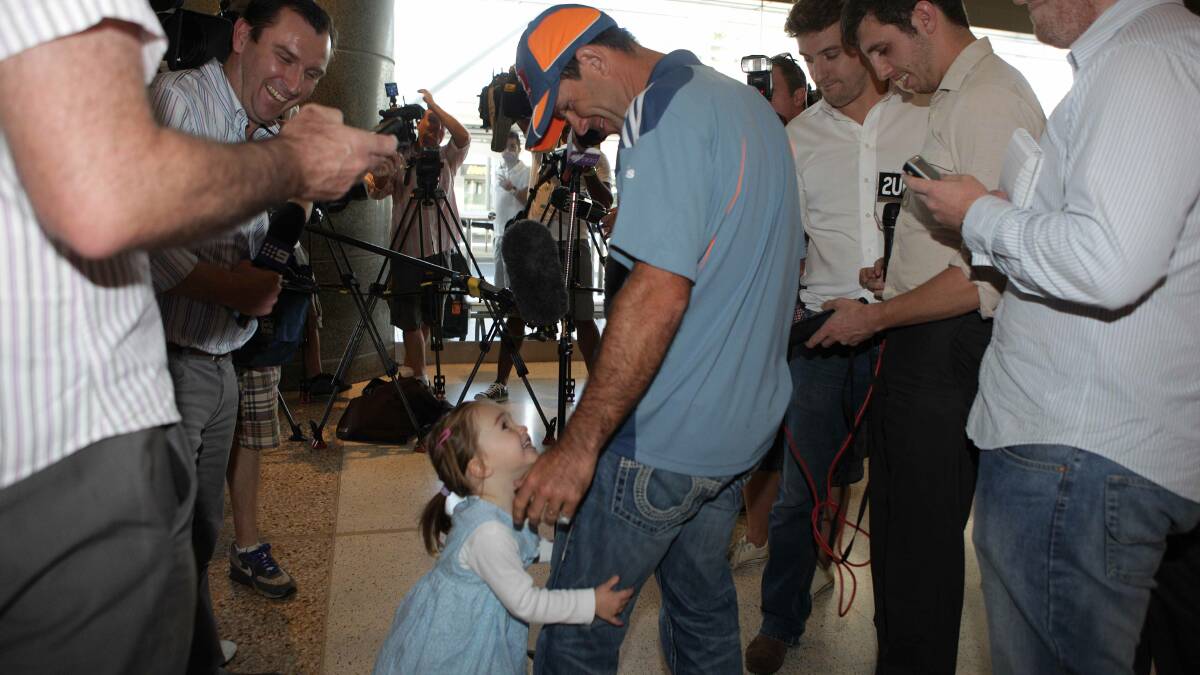 Ricky Ponting is accosted by his daughter Emmy before facing the press at Sydney Airport. Photo: LEE BESFORD