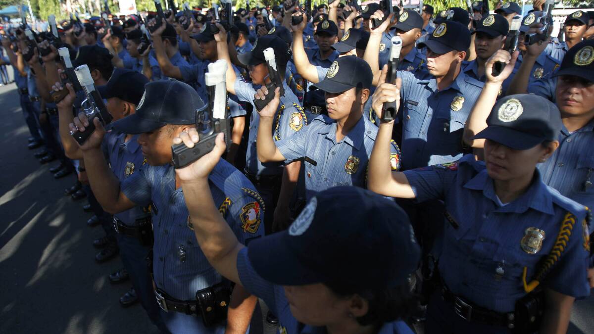 Philippine National Police tape the muzzles of their guns to avoid accidental discharges during New Year's celebrations. Photo: REUTERS