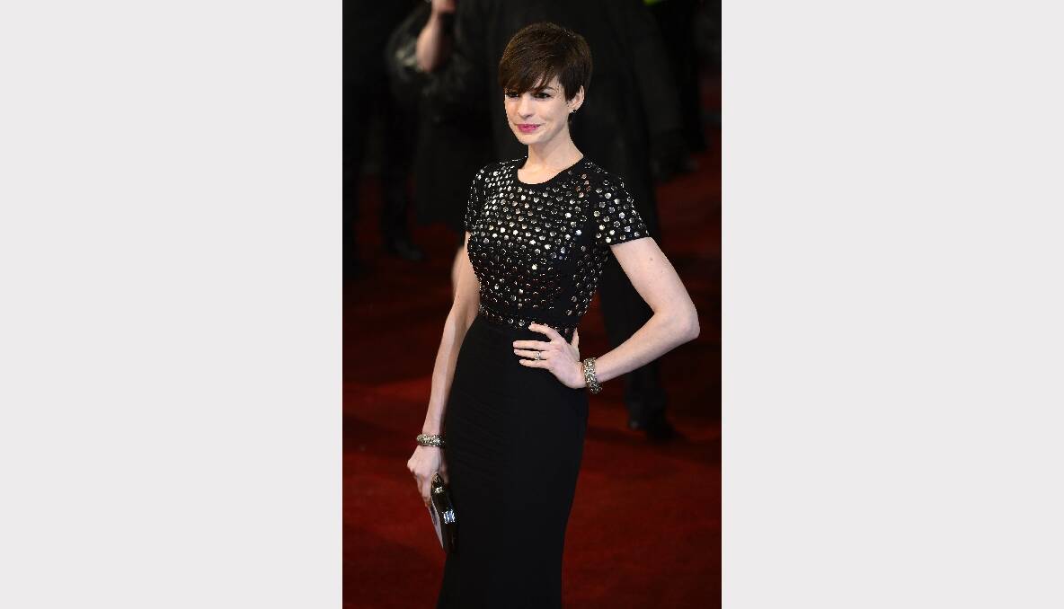 Anne Hathaway poses as she arrives for the British Academy of Film and Arts awards. Photos: GETTY IMAGES, REUTERS