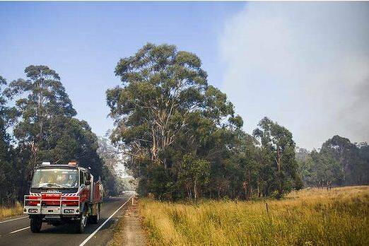 The scene from the Kings Highway. Crews work to contain fires near Bungendore. Photo: Rohan Thomson  