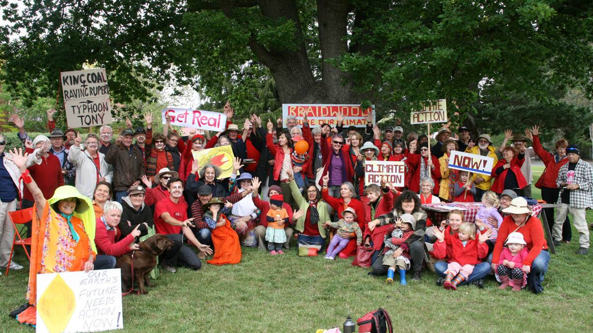 Locals rally in Ryrie park, wearing symbolically warm red and yellow colours, as part of the National Day of Climate Action. 