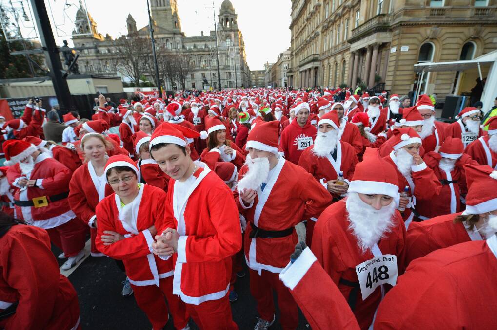 A thousand people take part in the annual Glasgow Santa Dash on November 9, 2012 in Glasgow, Scotland. Photo by Jeff J Mitchell/Getty Images