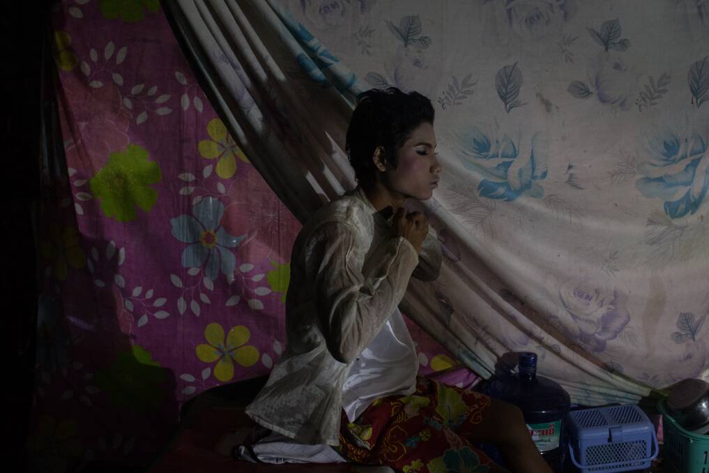 Performer Wai Yan Soe prepares to go on stage during the Phoe Chit Naing Orchestra Band performance at a rural carnival in South Dagon Township on February 14, 2013 in Yangon, Burma. Photo by Chris McGrath/Getty Images