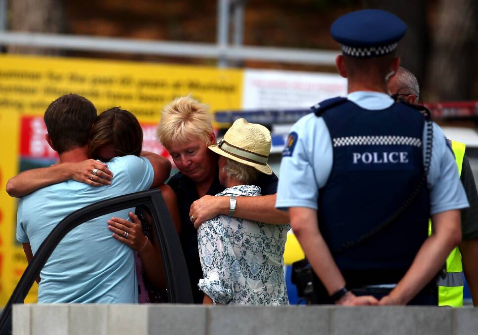 People grieve outside the Muriwai Surf Lifesaving Club after a swimmer died in a fatal shark attack at Muriwai Beach on February 27, 2013 in Auckland, New Zealand. Photo by Phil Walter/Getty Images