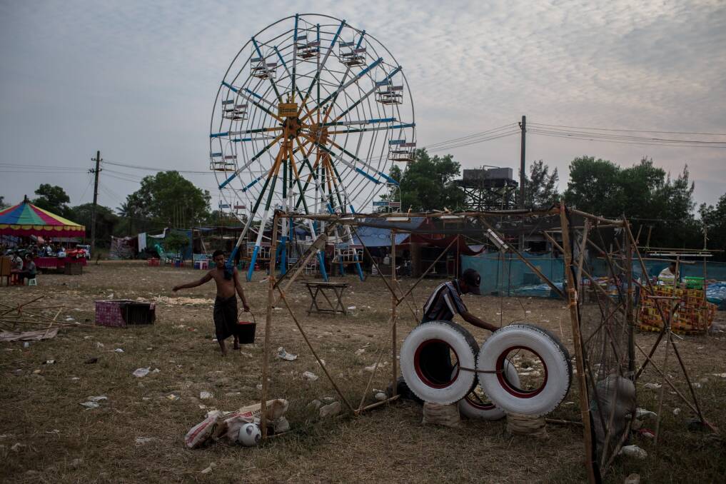 A carnival worker prepares an amusement stand ahead of the start of a rural carnival in South Dagon Township on February 14, 2013 in Yangon, Burma. Photo by Chris McGrath/Getty Images
