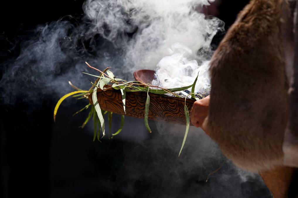 Aboriginal elder Associate Professor Simon Forrest performs a smoking ceremony to welcome HRH Prince Philippe of Belgium at Curtin University in Perth, Australia. Photo by Paul Kane/Getty Images