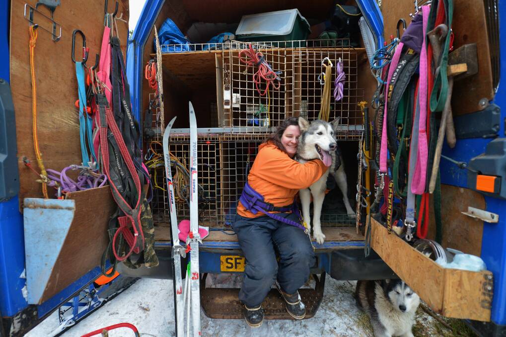 Louise Sugars hugs one of her husky dogs during practice for the Aviemore Sled Dog Rally in Feshiebridge, Scotland. Photo by Jeff J Mitchell/Getty Images