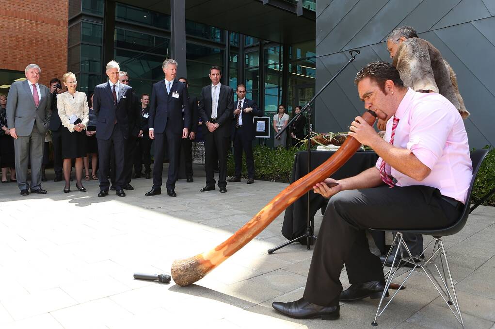 HRH Prince Philippe of Belgium looks on as Aboriginal elder Associate Professor Simon Forrest and Andrew Beck perform the welcome to country and smoking ceremony at Curtin University in Perth, Australia. Photo by Paul Kane/Getty Images 
