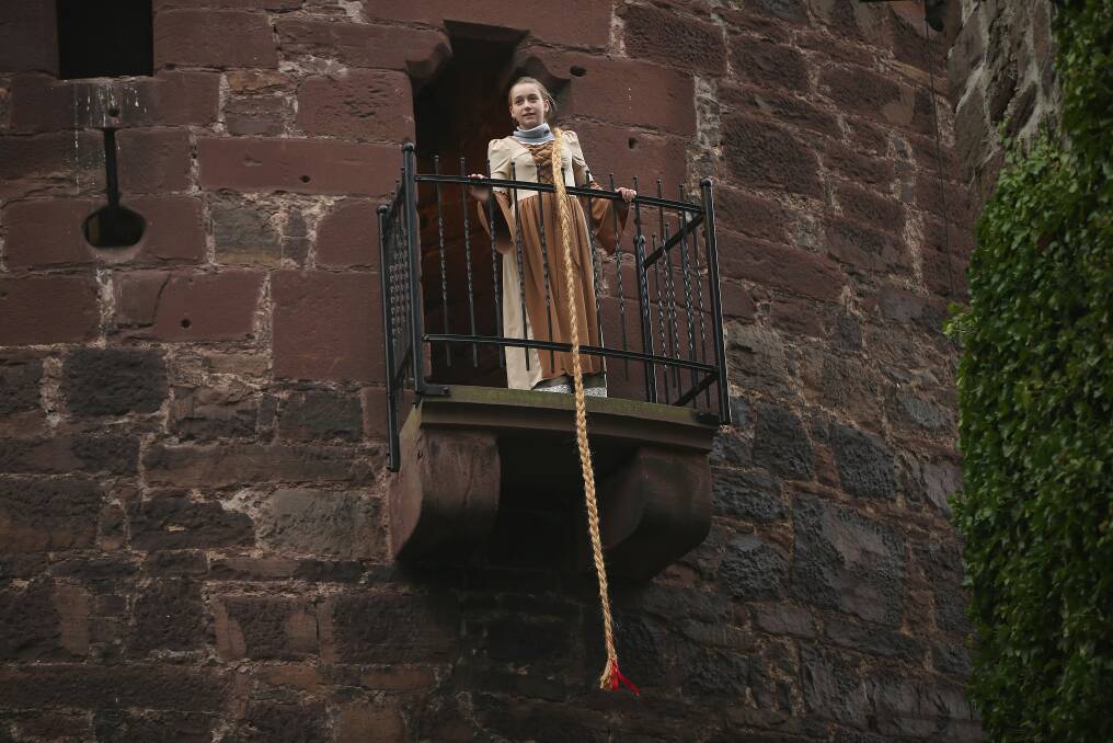 Rapunzel, actually 13-year-old actress Anna Helver, lets down her hair from a tower balcony of Trendelburg Castle to her prince in Trendelburg, Germany. Photo by Sean Gallup/Getty Images