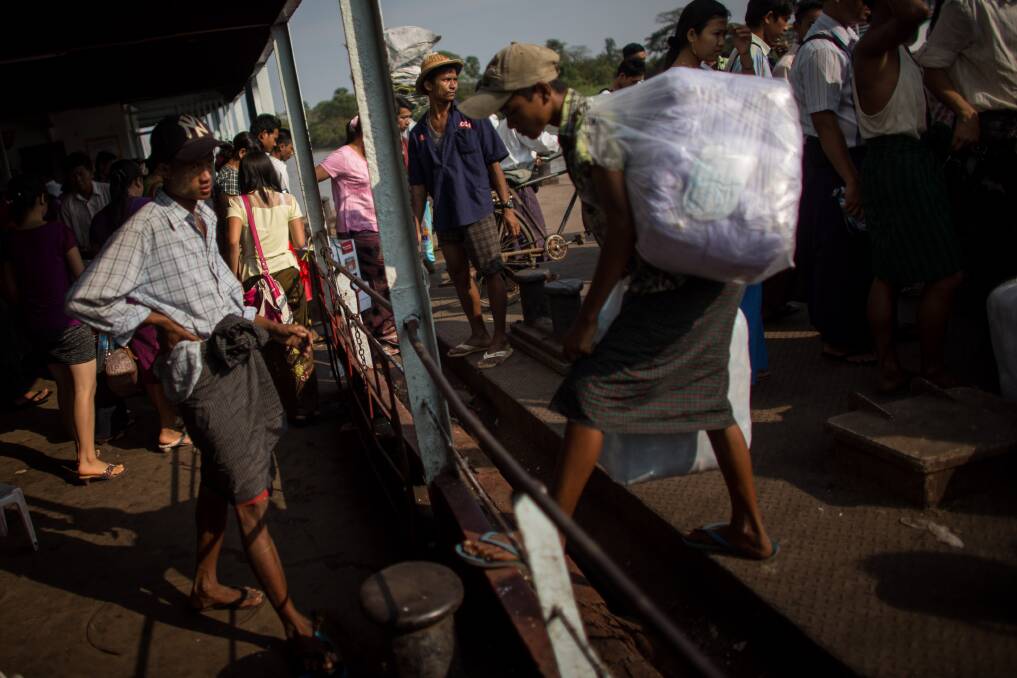 People get off the ferry at Dala jetty on February 11, 2013 in Yangon, Burma. Photo: Chris McGrath/Getty Images