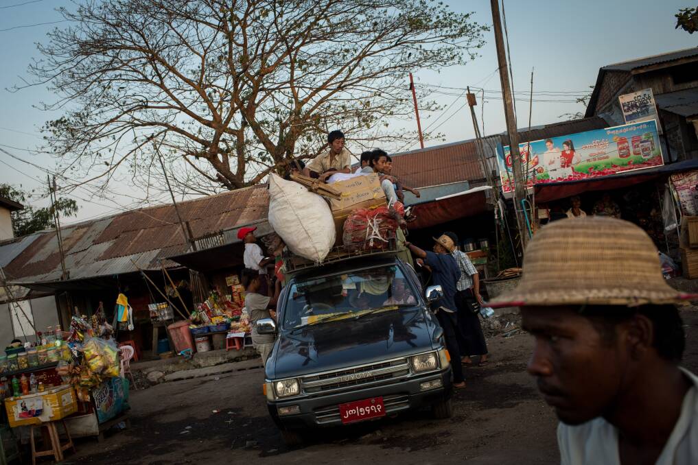 People pile up a car with produce and materials at the Dala Jetty on February 11, 2013 in Yangon, Burma. Photo by Chris McGrath/Getty Images