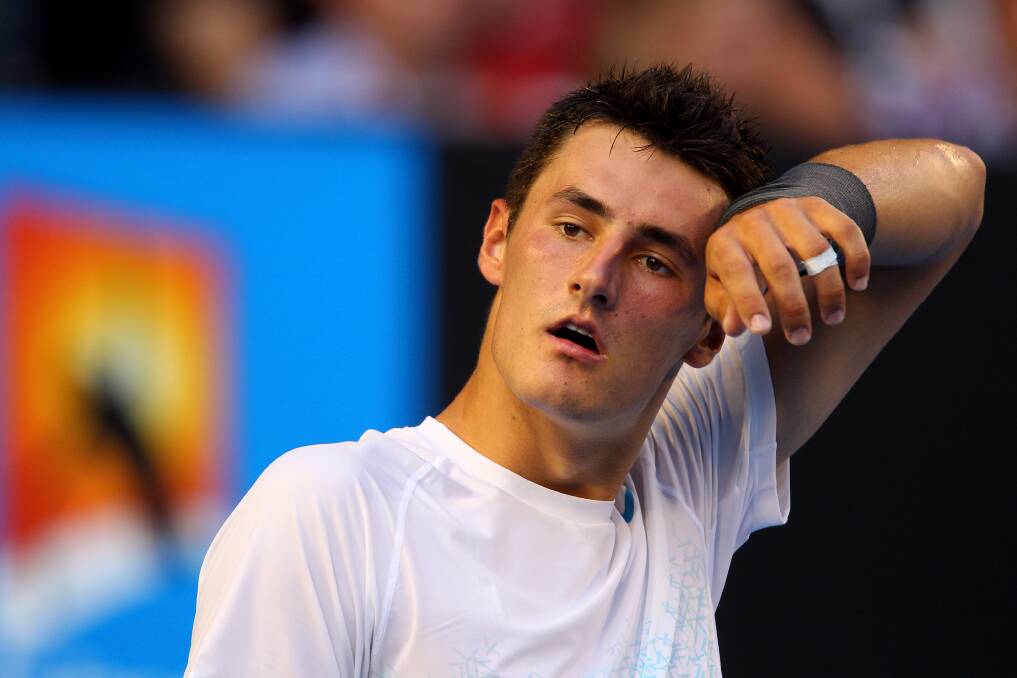 Bernard Tomic of Australia wipes his brow in his first round match against Leonardo Mayer of Argentina during day two of the 2013 Australian Open. Photo by Robert Prezioso/Getty Images