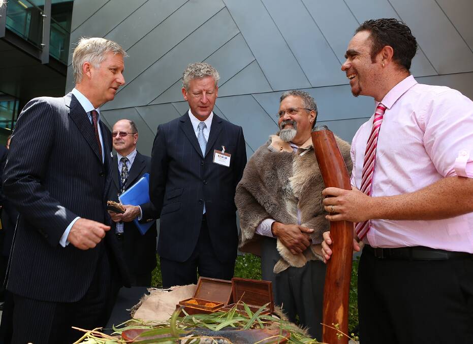 HRH Prince Philippe and Belgian Minister of Defence HE Me Pieter De Crem, talk with Aboriginal elder Associate Professor Simon Forrest and Andrew Beck (R) after being welcomed with a smoking ceremony at Curtin University in Perth, Australia. Photo by Paul Kane/Getty Images