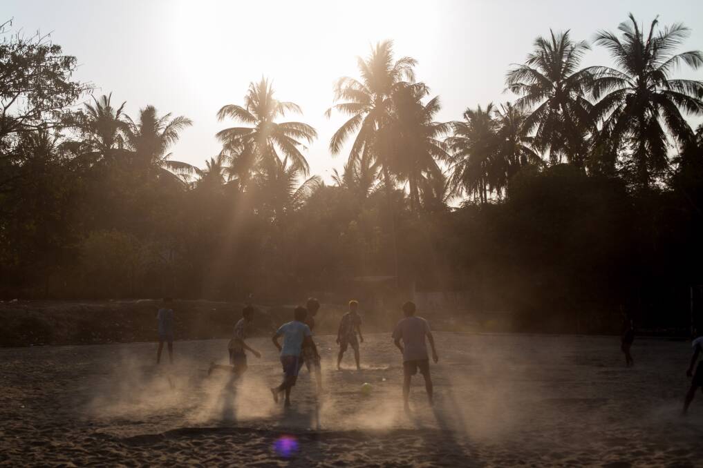 Men play soccer in Dala Township on February 11, 2013 in Yangon, Burma. Photo by Chris McGrath/Getty Images